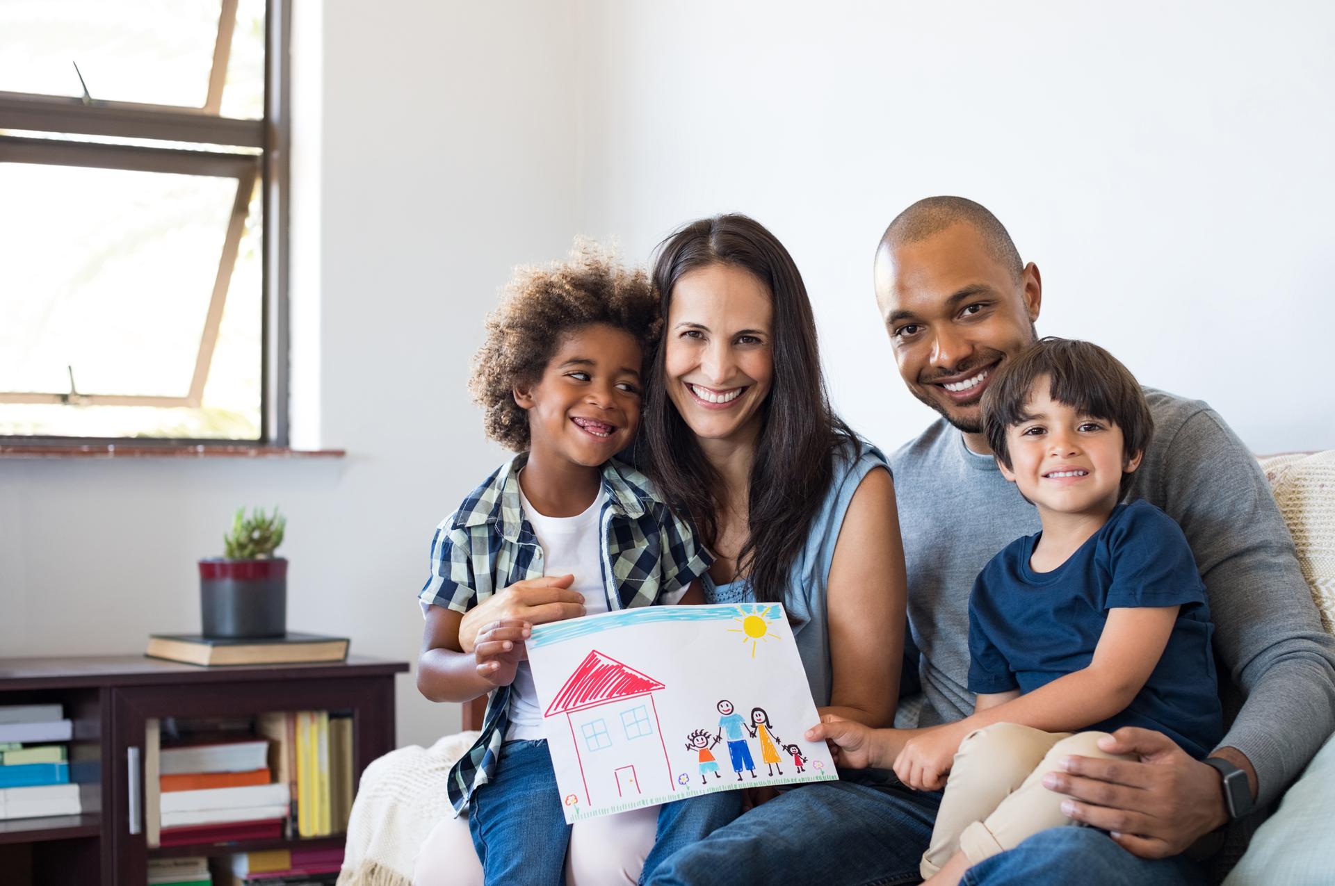 Multiethnic family on sofa saving energy with utility rebates