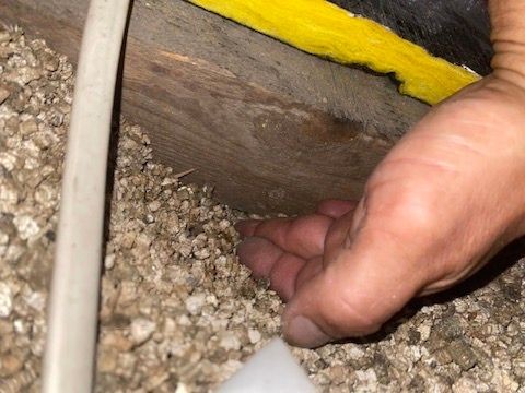 Cold air return passing through attic with vermiculite insulation — potential leakage and IAQ risk identified by Project Probono LLC in the Lehigh Valley